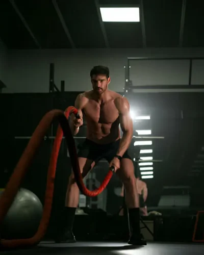 Man doing cross training exercise with rope
